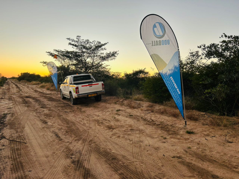 OddBall branded banner on a site road at sunset