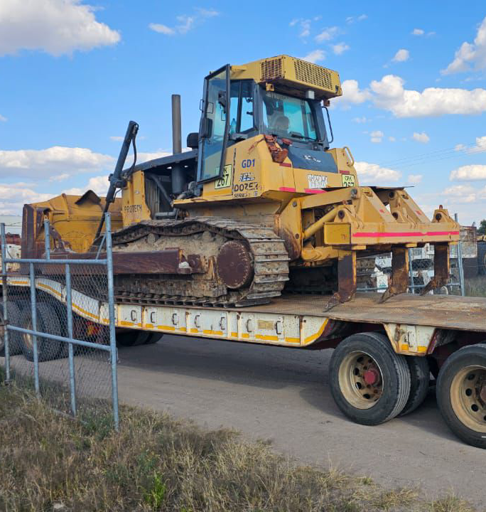 Bulldozer clearing thick bush on an OddBall site