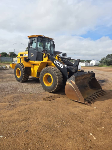 Front-end loader handling bulk material on site