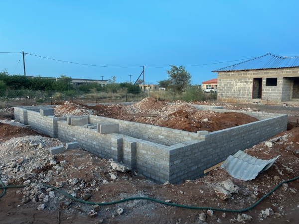 Bricklayer building a block wall on an OddBall construction site